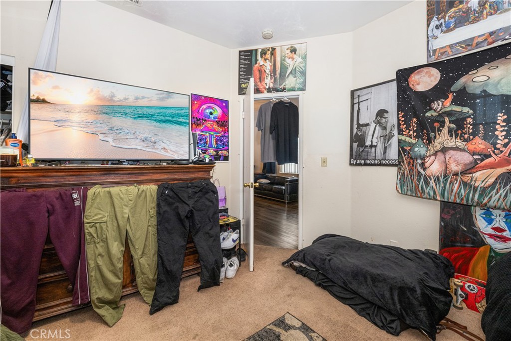9722 Walnut Street Bellflower, CA 90706 - Photo 40 of 55 a bedroom with a bed and a walk in closet
