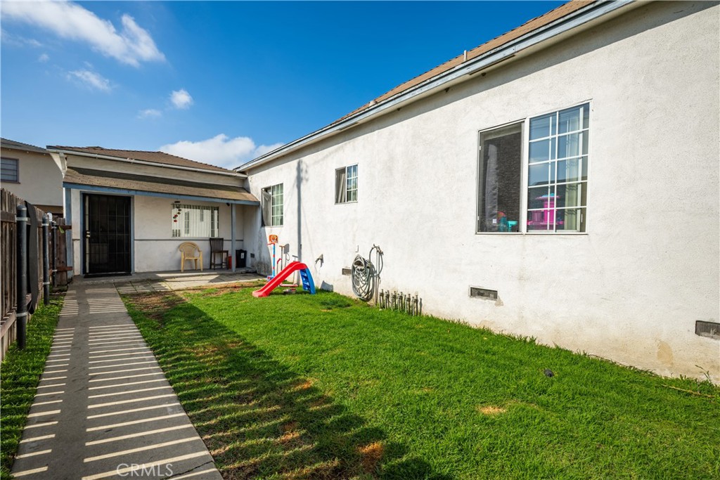 9722 Walnut Street Bellflower, CA 90706 - Photo 46 of 55 a view of a backyard with plants and a patio
