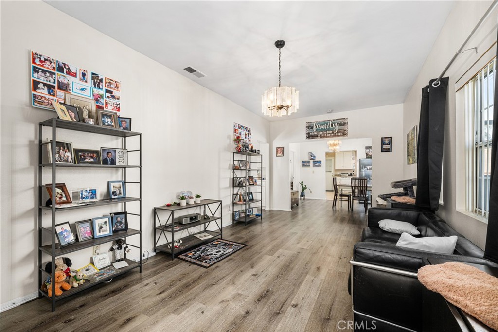 9722 Walnut Street Bellflower, CA 90706 - Photo 6 of 55 a living room with furniture and a book shelf