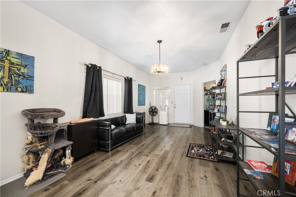 9722 Walnut Street Bellflower, CA 90706 - Photo 9 of 55 a living room with furniture a couch and wooden floor