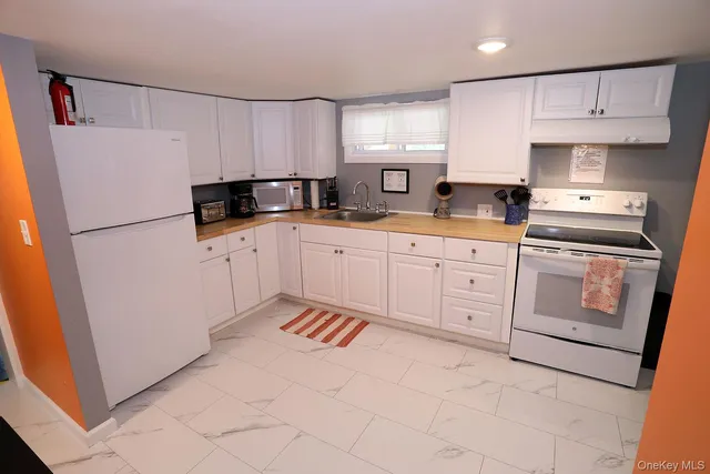 a kitchen with appliances cabinets and a sink