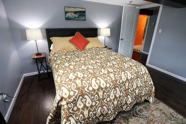 a large bed sitting in a bedroom next to a lamp