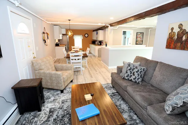 a living room with furniture rug and wooden floor