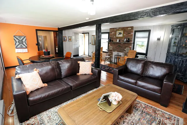 a living room with furniture rug and window