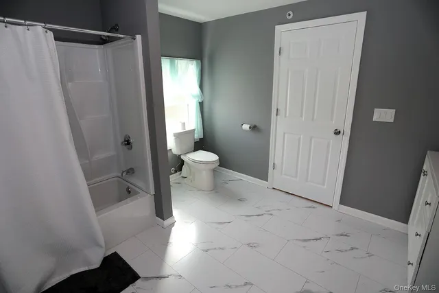 a bedroom with two beds and painting on the wall