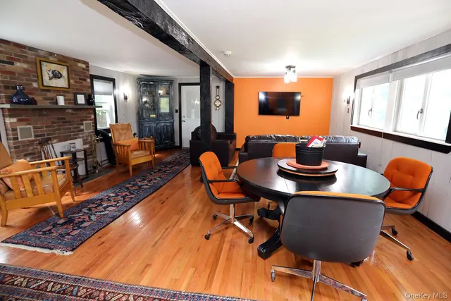 a dining room with furniture a rug and a floor to ceiling window