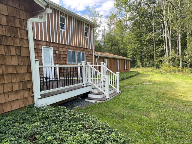 an aerial view of a house with a yard