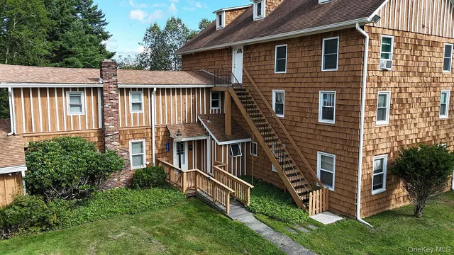 a view of a green yard with large trees