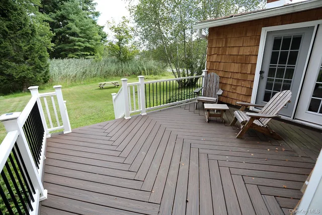 a view of a deck with two chairs and a wooden floor