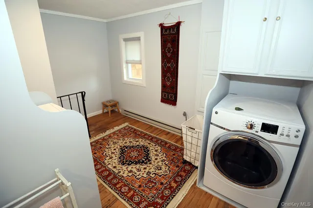 a view of a hallway with washer and dryer