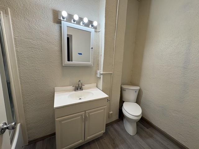 4876 East Williams Spring Road Fort Worth, TX 76135 - Photo 18 of 20 a bathroom with a toilet sink and mirror