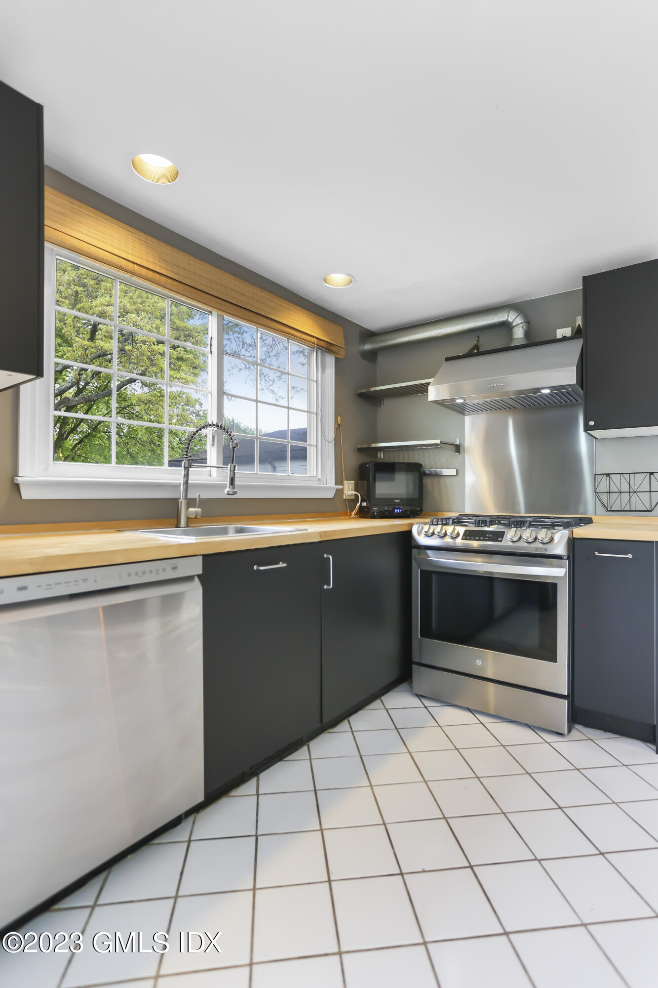 16 Pemberwick Road Greenwich, CT 06831 - Photo 4 of 32 a kitchen with a stove a sink and a microwave