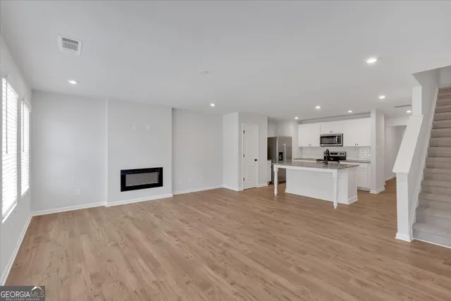 a view of kitchen with microwave and refrigerator
