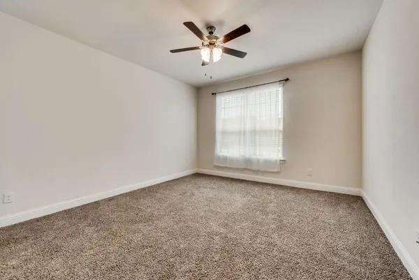a bathroom with a granite countertop sink a toilet and a mirror