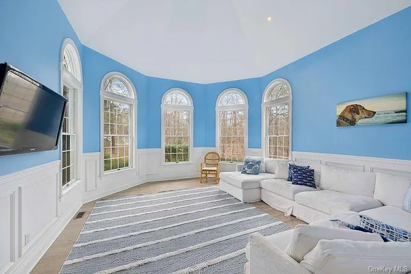 a bedroom with furniture and a flat screen tv