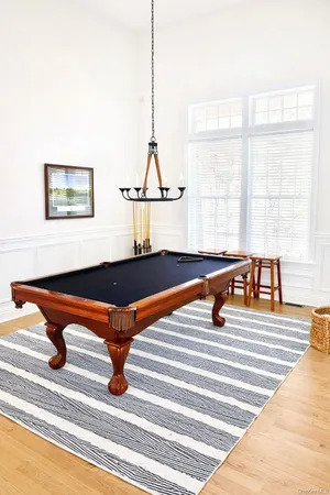 a living room with a table chairs and a table