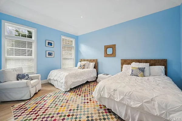 a bedroom with two beds and a couch