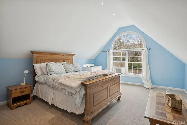 a spacious bedroom with a bed and a window