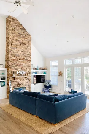 a living room with stainless steel appliances kitchen island granite countertop furniture a rug and a view of kitchen
