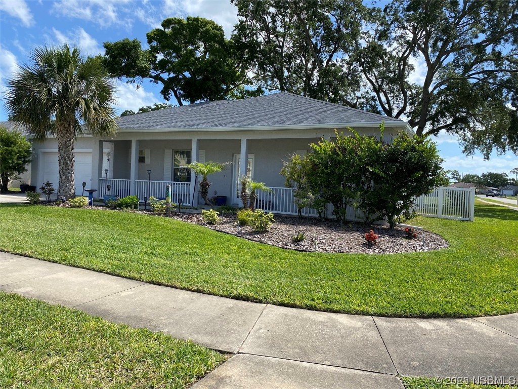 339 Mariners Gate Drive Edgewater, FL 32141 - Photo 1 of 2 a front view of a house with a garden and plants