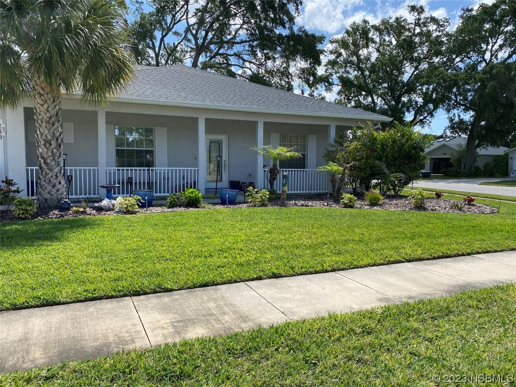 339 Mariners Gate Drive Edgewater, FL 32141 - Photo 2 of 2 a front view of a house with a yard and trees