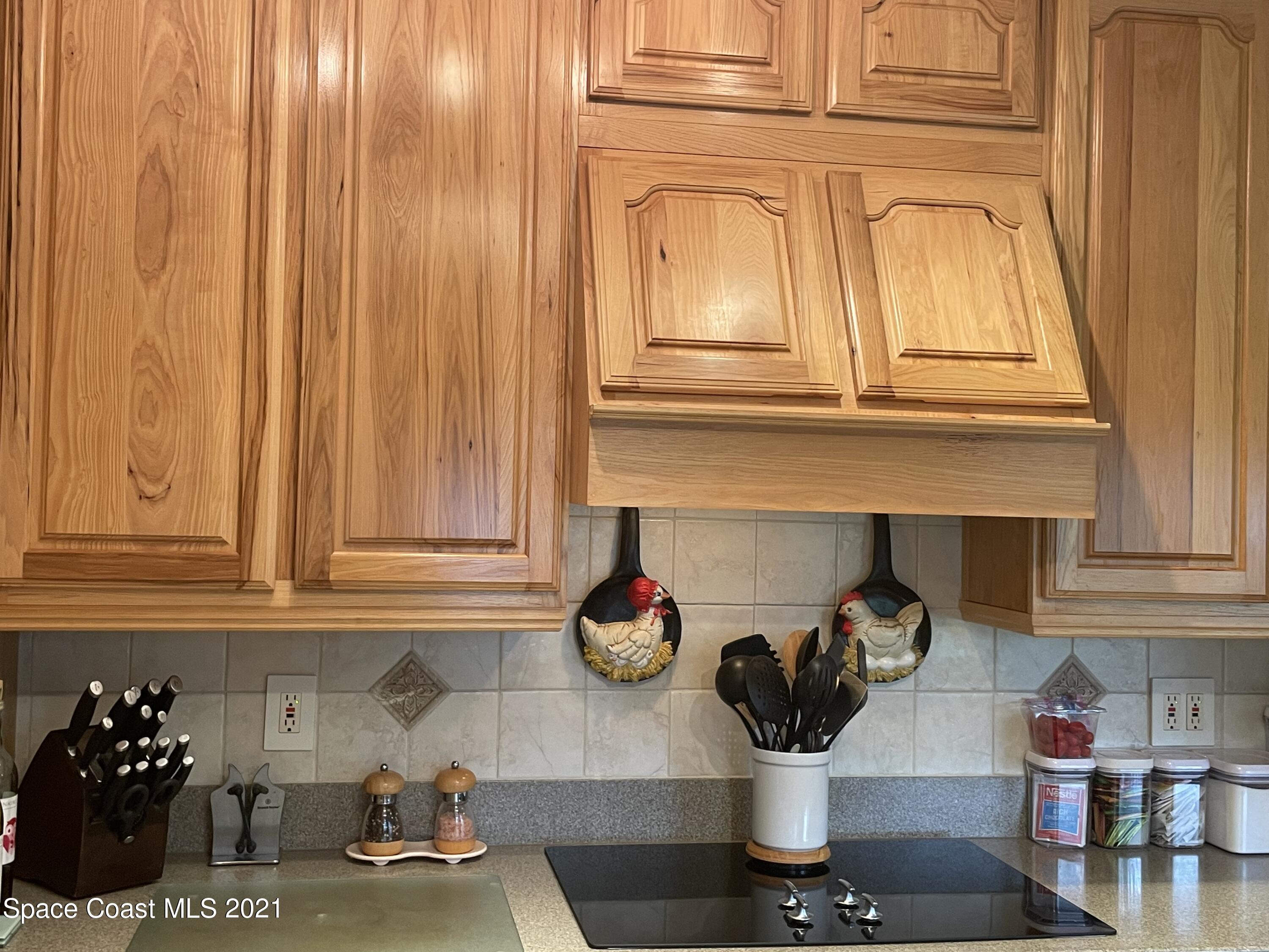 1937 Trimble Road Melbourne, FL 32934 - Photo 5 of 7 a kitchen with a refrigerator and cabinets