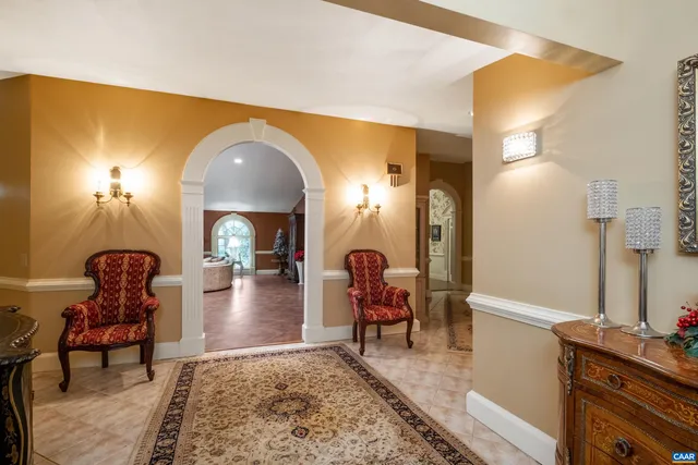 a dining room with furniture a fireplace and large windows