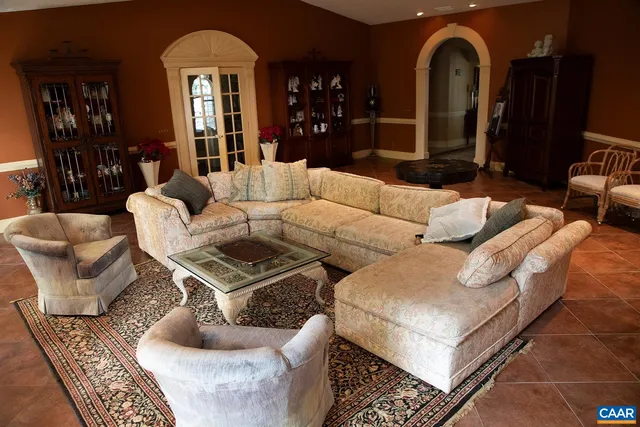 a spacious bedroom with a bed couch and a large window