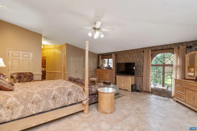 a living room with furniture a piano and a floor to ceiling window