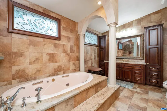 a living room with furniture a rug and a painting on the wall