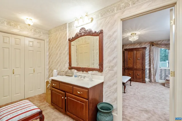 a view of hall way with furniture and closet