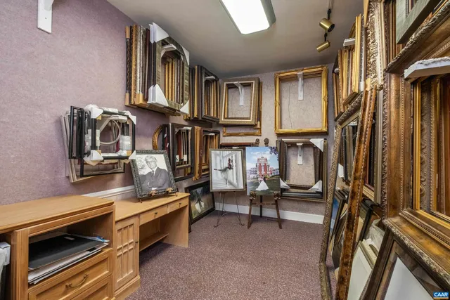 a living room with patio furniture and a potted plant