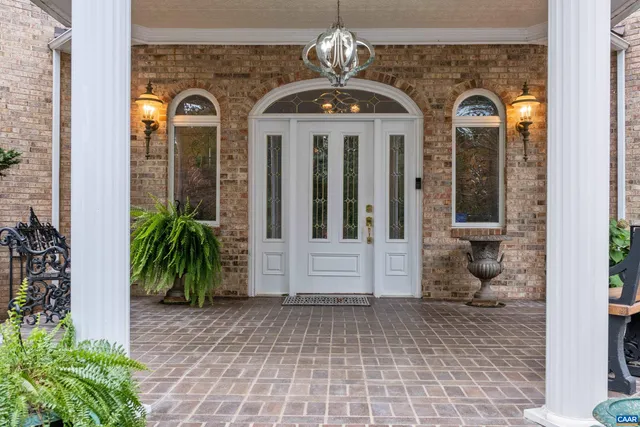 a living room with furniture a rug a lamp and a window