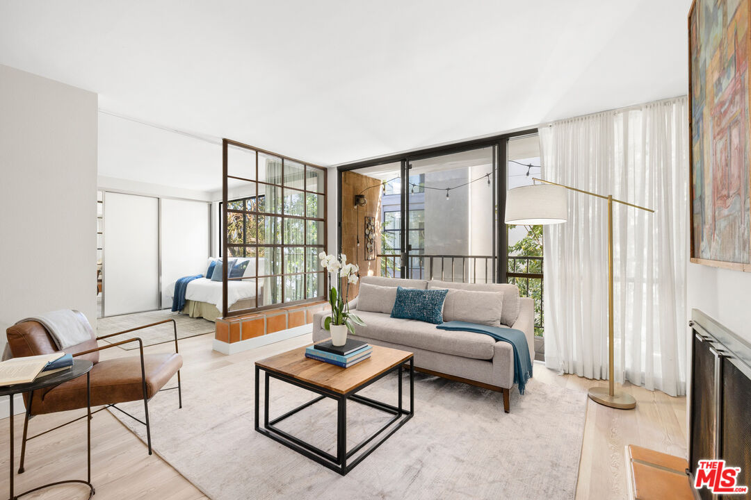 a living room with furniture and a floor to ceiling window