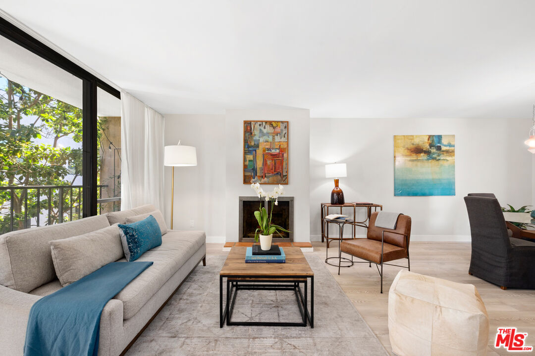 10966 Rochester Avenue, Unit 3F Los Angeles, CA 90024 - Photo 2 of 11 a living room with furniture fireplace and large window