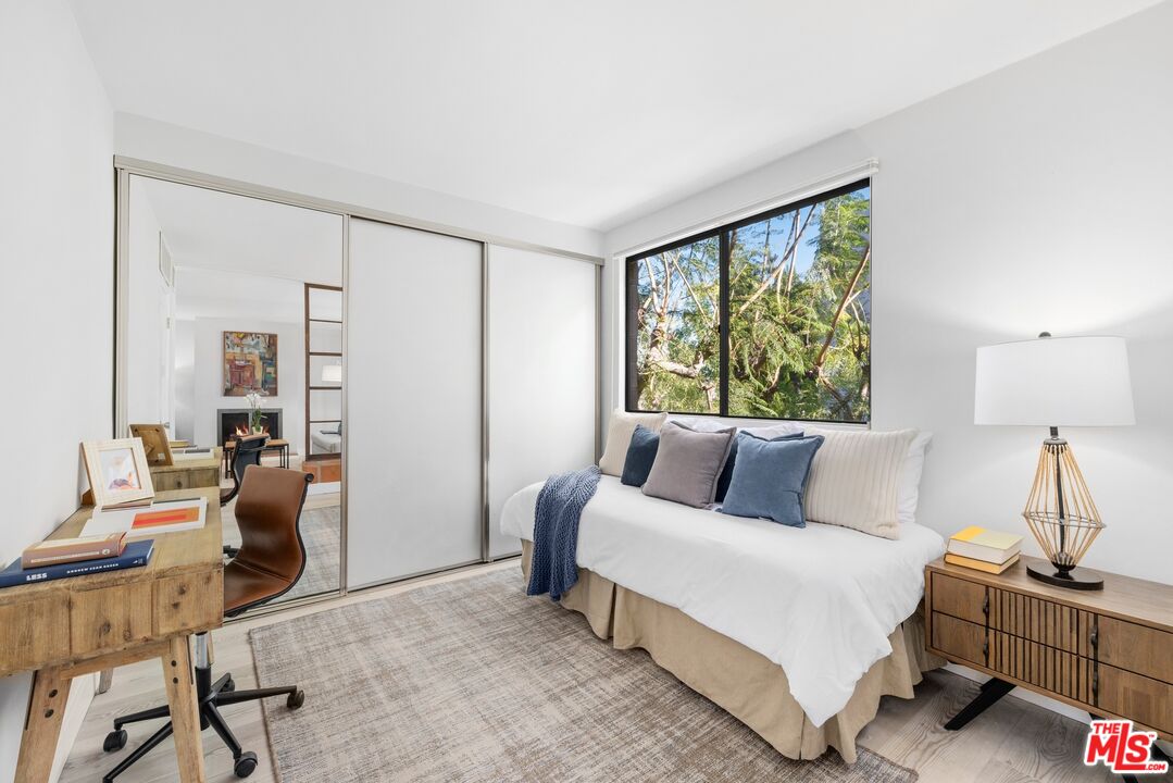 10966 Rochester Avenue, Unit 3F Los Angeles, CA 90024 - Photo 5 of 11 a bedroom with a bed and large window