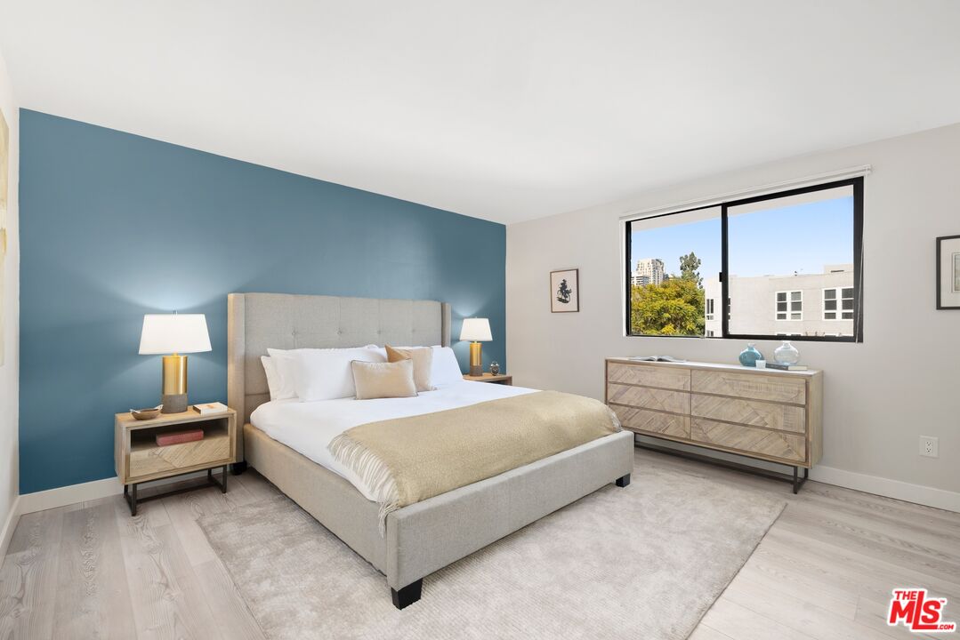 10966 Rochester Avenue, Unit 3F Los Angeles, CA 90024 - Photo 6 of 11 a bedroom with a bed and a couch