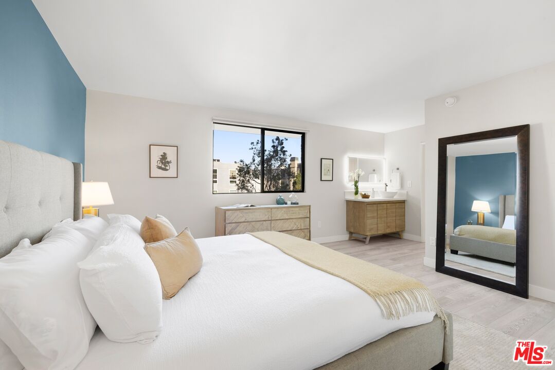 10966 Rochester Avenue, Unit 3F Los Angeles, CA 90024 - Photo 7 of 11 a bedroom with a bed and a couch