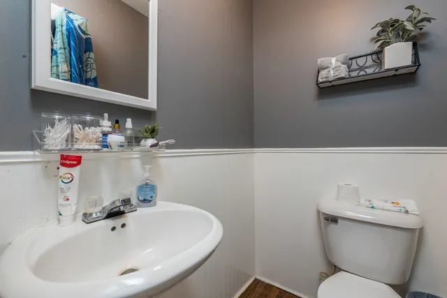 a bathroom with a sink mirror and toilet