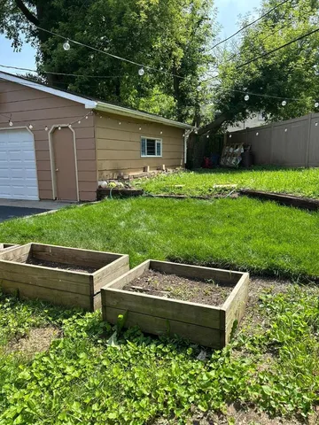 a view of a backyard with sitting area