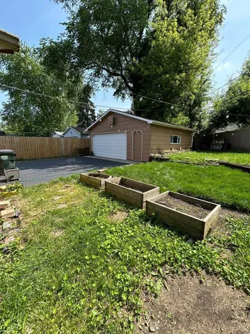 a backyard of a house with table and chairs