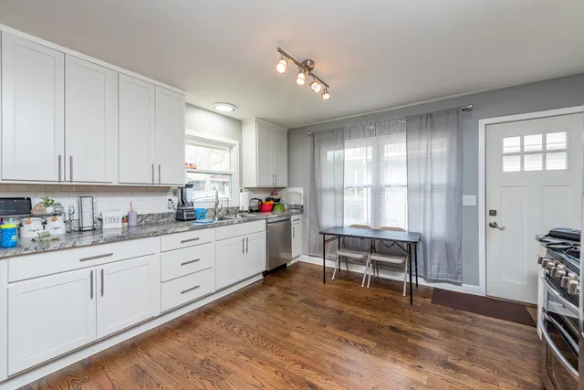 a kitchen with sink cabinets and wooden floor