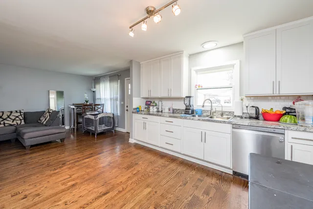 a kitchen with sink cabinets and wooden floor