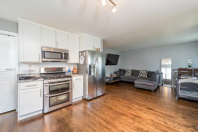 a kitchen with stainless steel appliances a stove a refrigerator sink and microwave