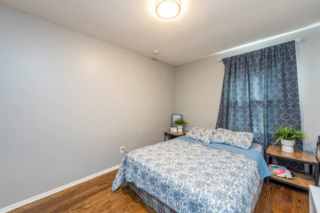 a bedroom with a bed and a potted plant