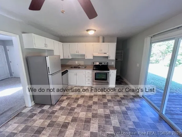 a view of a refrigerator in kitchen and a sink
