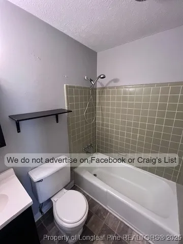 a bathroom with a toilet a sink and bathtub
