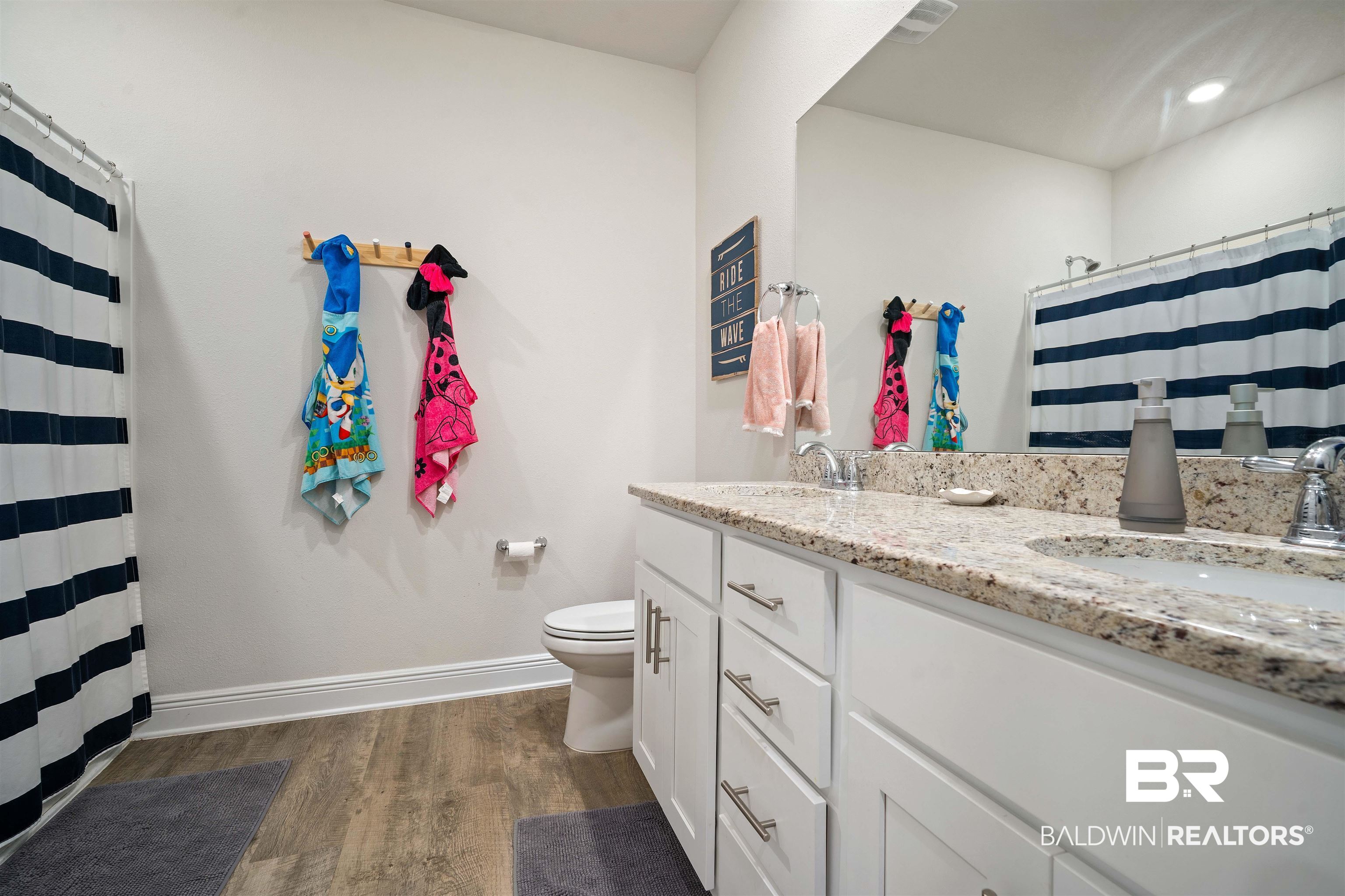 11021 Native Dancer Way Daphne, AL 36526 - Photo 18 of 35 Full bathroom with toilet, wood finished floors, a sink, double vanity, and baseboards