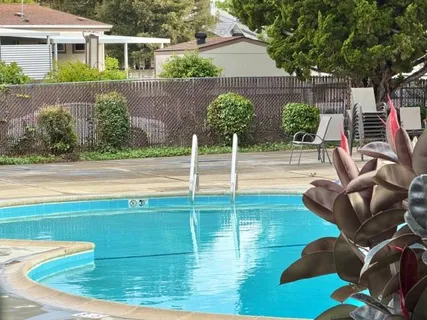 a view of swimming pool with seating space