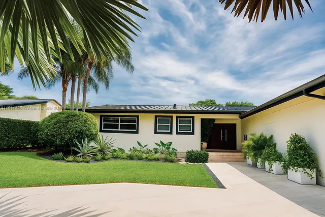 a front view of house with yard and green space